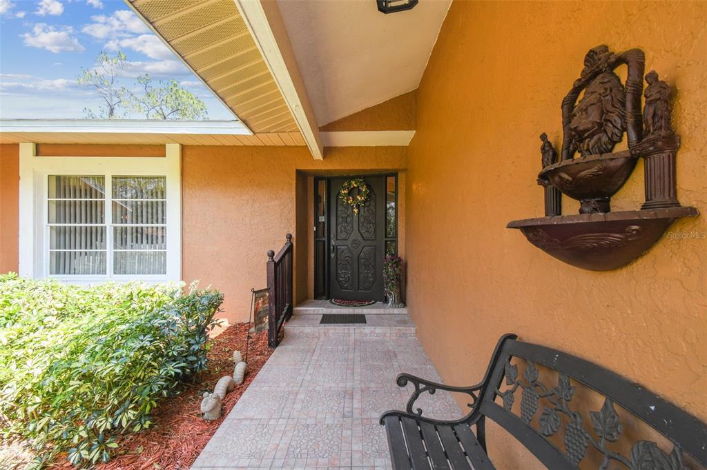 6938 Coronet Drive New Port Richey, FL 34655 - Photo 6 of 49 a view of a porch with a table and chairs