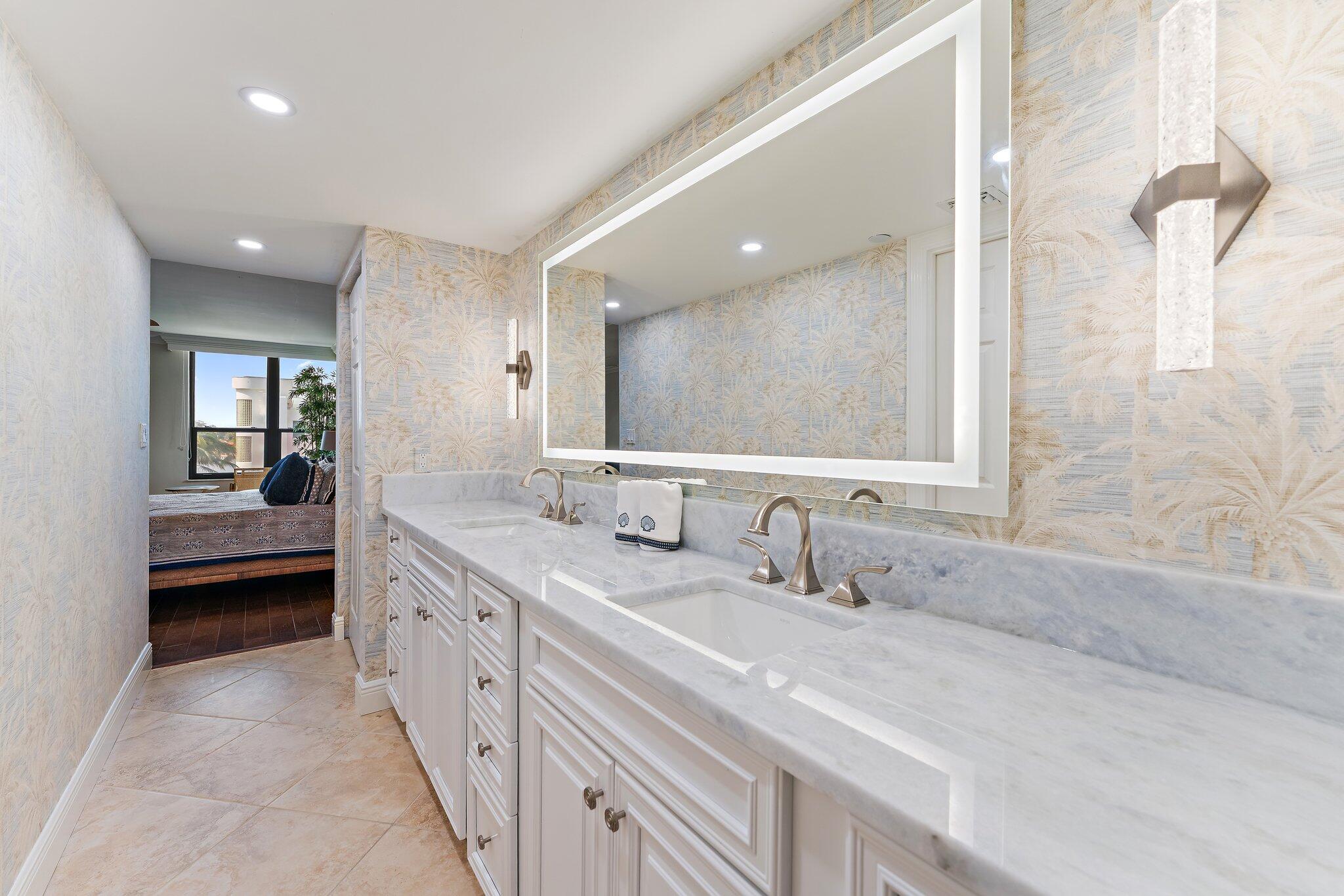 19670 South Beach Road, Unit B303 Jupiter, FL 33469 - Photo 39 of 104 a bathroom with a double vanity sink and mirror with shower
