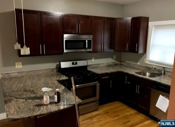 a kitchen with a sink stove and microwave