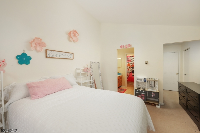 28 Spruce Court Bedminster, NJ 07921 - Photo 11 of 12 a bedroom with a bed and a chandelier