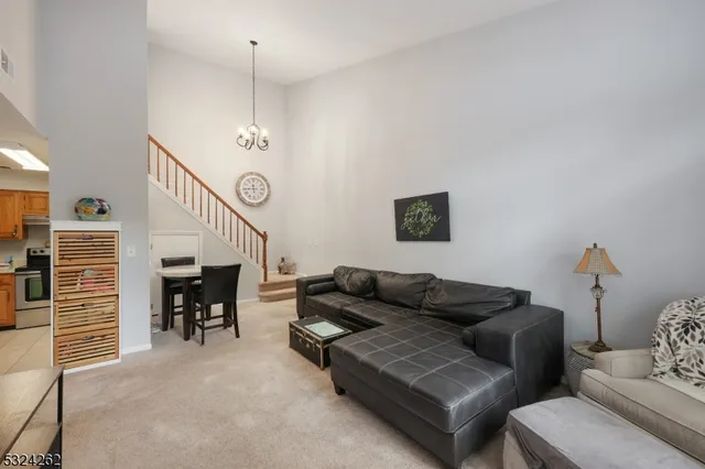 a living room with furniture and a chandelier