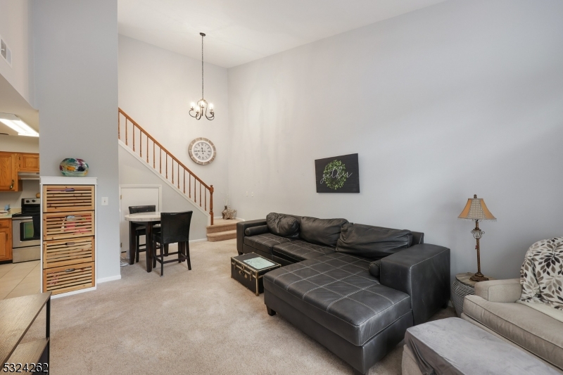 28 Spruce Court Bedminster, NJ 07921 - Photo 3 of 12 a living room with furniture and a chandelier