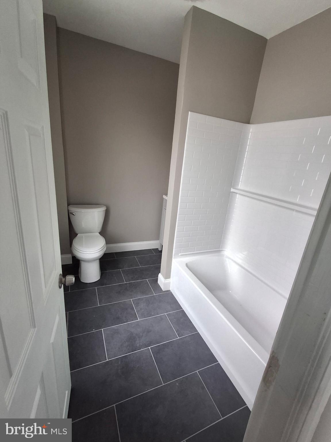 319 Taylor Street Riverside, NJ 08075 - Photo 2 of 4 a bathroom with a toilet and a bathtub