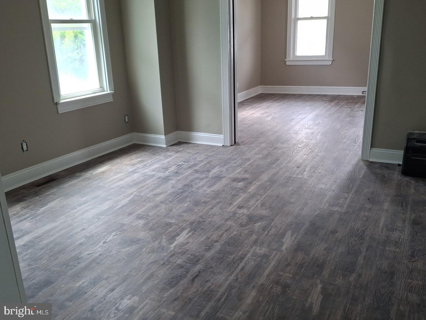319 Taylor Street Riverside, NJ 08075 - Photo 4 of 4 an empty room with wooden floor and windows