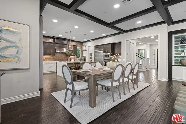 a view of a dining room with furniture wooden floor and kitchen