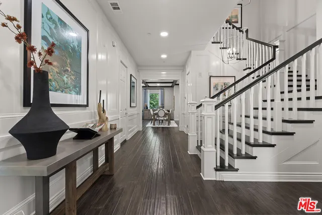 a view of entryway and hall with wooden floor