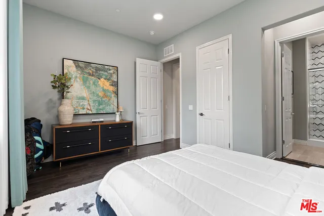 a bedroom with a bed and a dresser