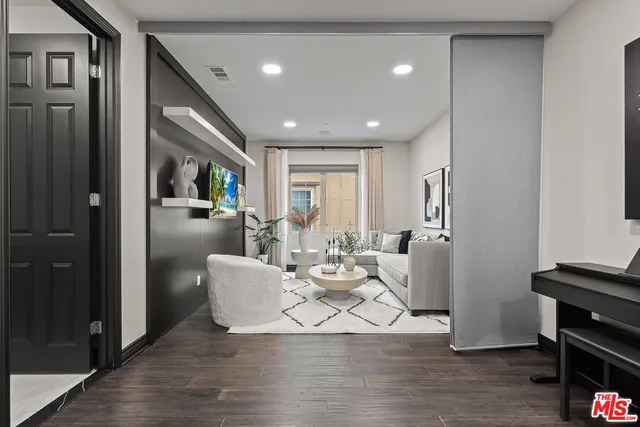 a living room with furniture and wooden floor