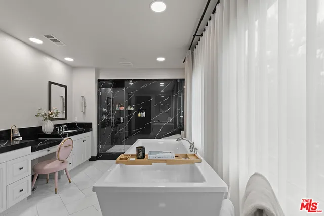 a kitchen with a white stove next to a window
