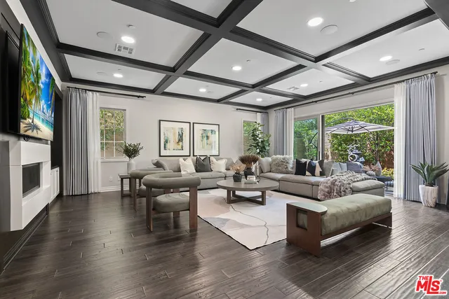 a living room with fireplace furniture and a flat screen tv