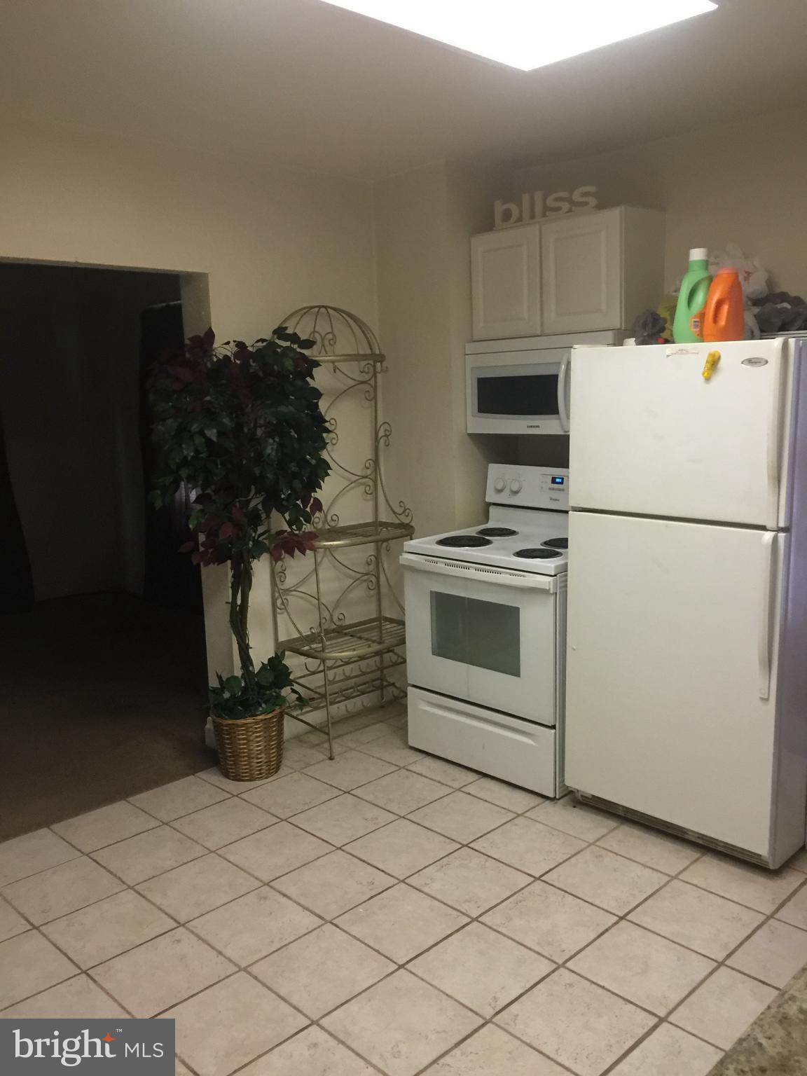 226 Poplar Street Hanover, PA 17331 - Photo 3 of 4 a white kitchen with a stove and a refrigerator