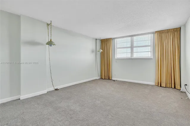 a view of a swimming pool with chairs in patio