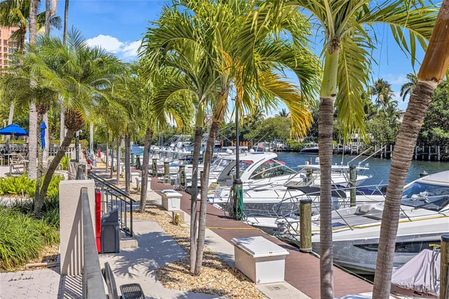 a kitchen with stainless steel appliances kitchen island granite countertop a refrigerator and a sink