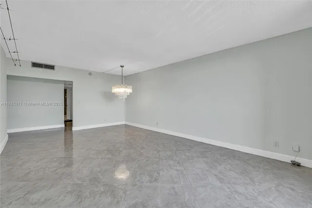 a kitchen with stainless steel appliances granite countertop a sink a refrigerator and a cabinets