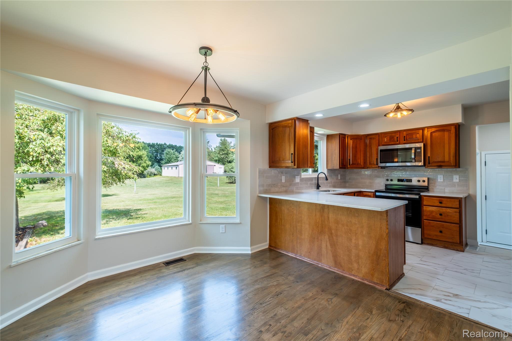5181 East Burnside Road North Branch, MI 48461 - Photo 4 of 34 Bay window dining area with wood-finish flooring