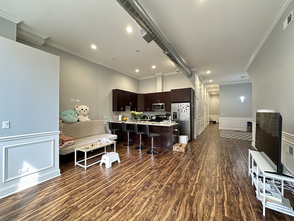3336 West Irving Park Road, Unit 1 Chicago, IL 60618 - Photo 12 of 20 a living room with furniture and a flat screen tv