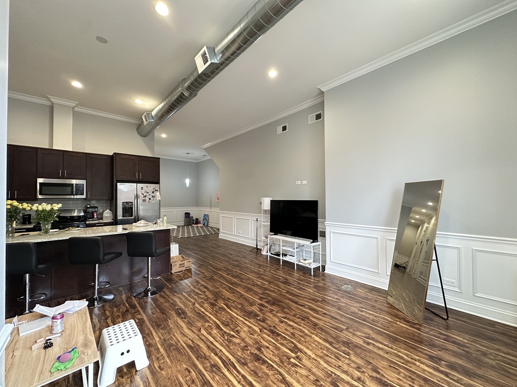 3336 West Irving Park Road, Unit 1 Chicago, IL 60618 - Photo 10 of 20 a living room with furniture and a flat screen tv