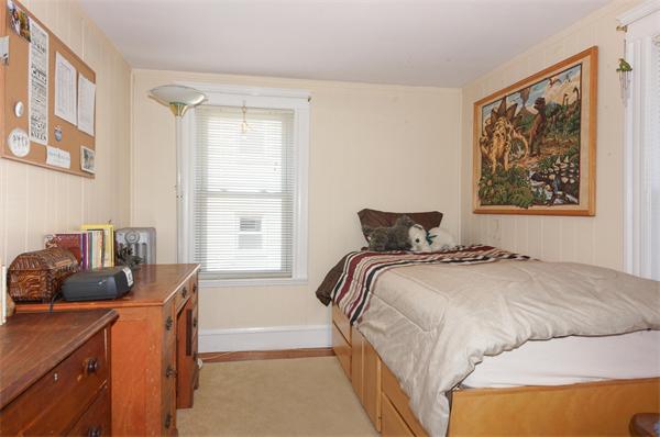 15 Sutherland Road Arlington, MA 02476 - Photo 8 of 22 a bedroom with a bed and a window