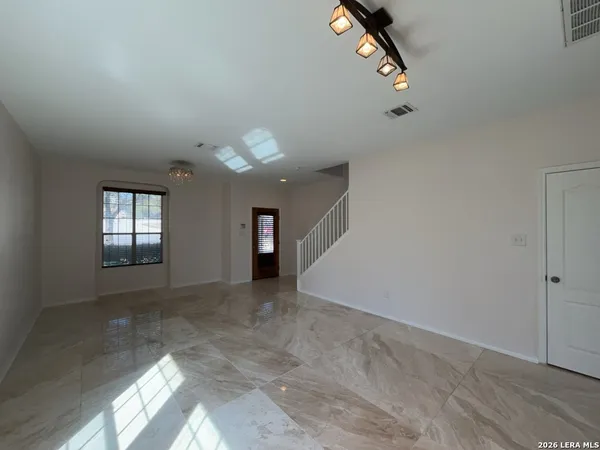 a living room with a fireplace and a ceiling fan