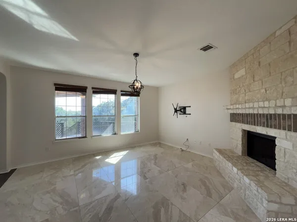 a view of a kitchen with a sink and a fireplace