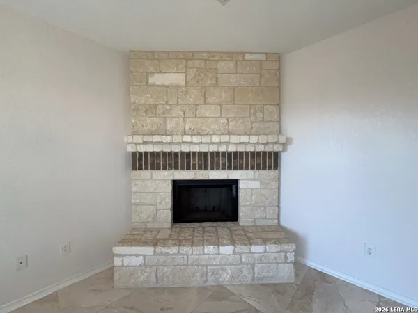 a view of a livingroom with a chandelier fan and fire place