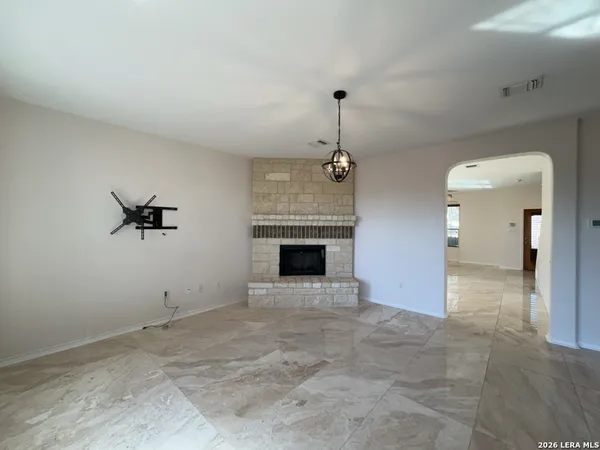 a large kitchen with kitchen island a large counter top space a sink stainless steel appliances and cabinets