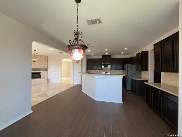 a kitchen with a refrigerator and a sink
