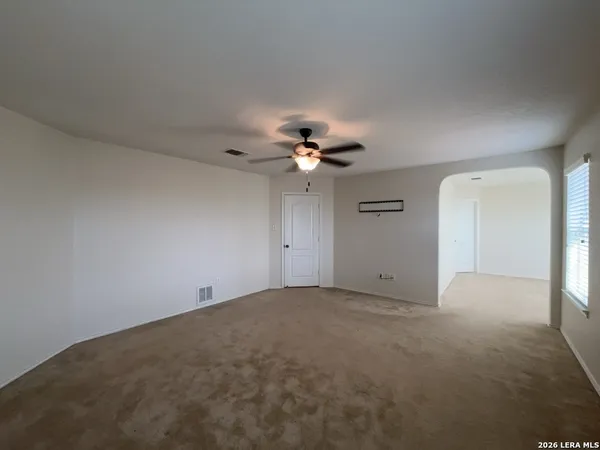 a bathroom with double vanity and a mirror