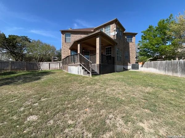 a view of a house with swimming pool and sitting area