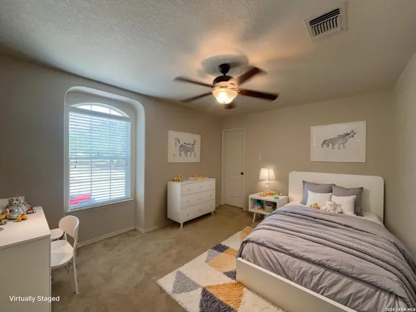 a bedroom with furniture and a window