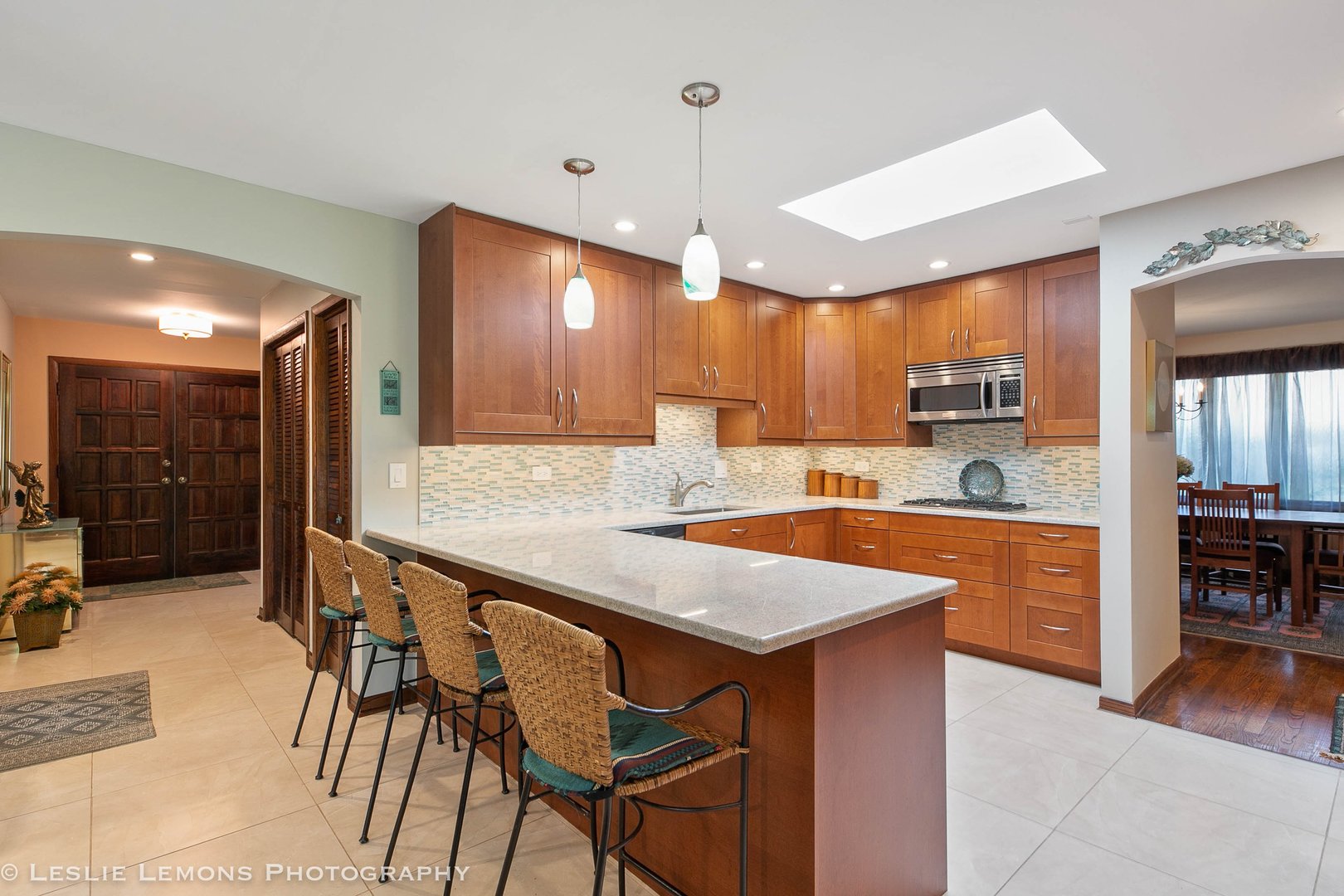 3192 Beller Drive Darien, IL 60561 - Photo 2 of 50 a large kitchen with kitchen island a stove a sink a dining table and chairs