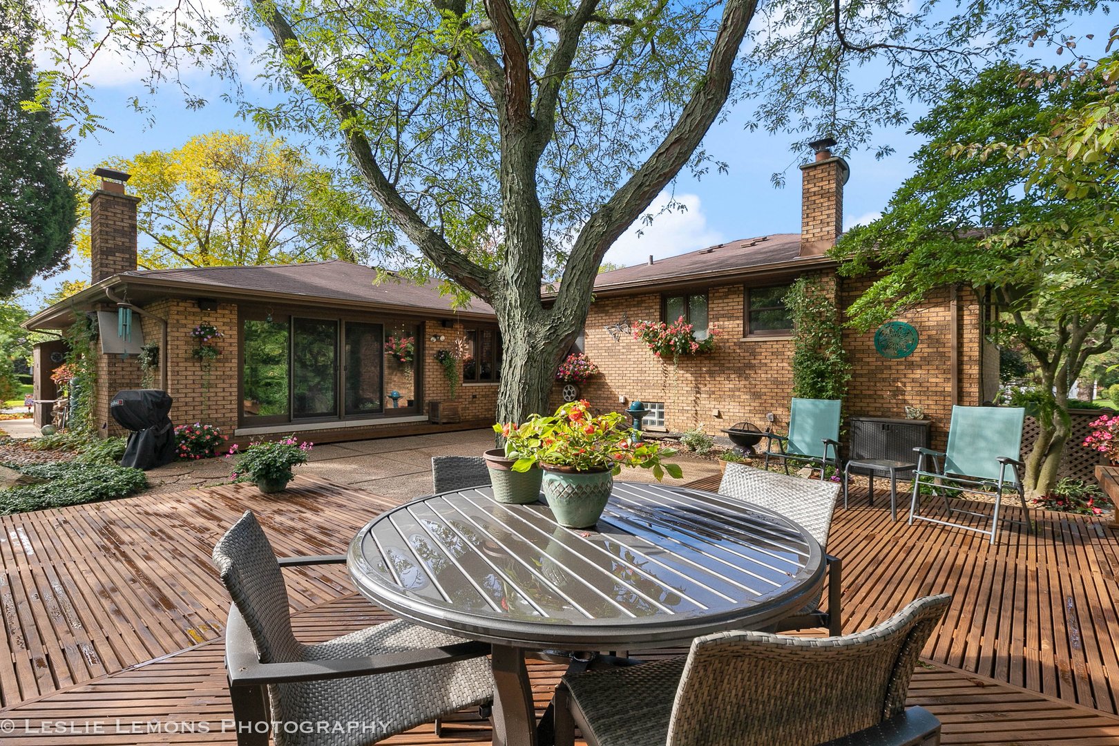 3192 Beller Drive Darien, IL 60561 - Photo 38 of 50 a view of a patio with table and chairs potted plants and large tree