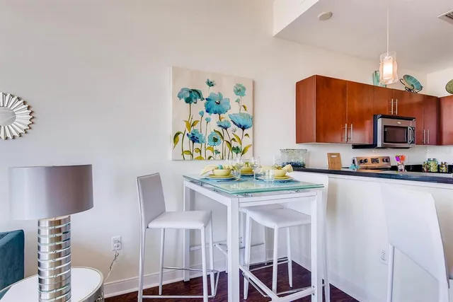 a bedroom with a large bed and a lamp