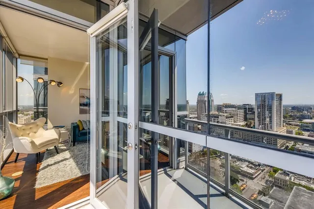 a living room with patio furniture and a potted plant