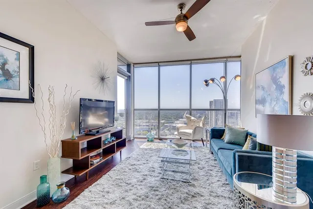 a living room with furniture and a flat screen tv
