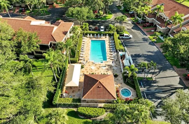 an aerial view of a house with a yard and potted plants