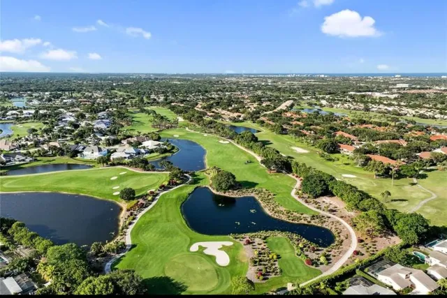 an aerial view of residential houses with outdoor space and trees