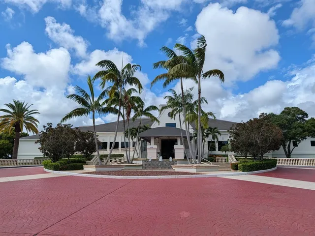 a group of palm trees in front of building