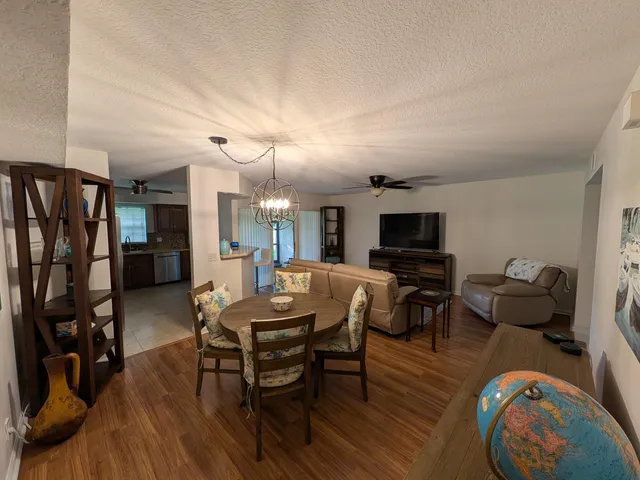 a view of a livingroom with furniture and a flat screen tv