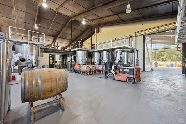 a bedroom with a bed and a couch next to a window