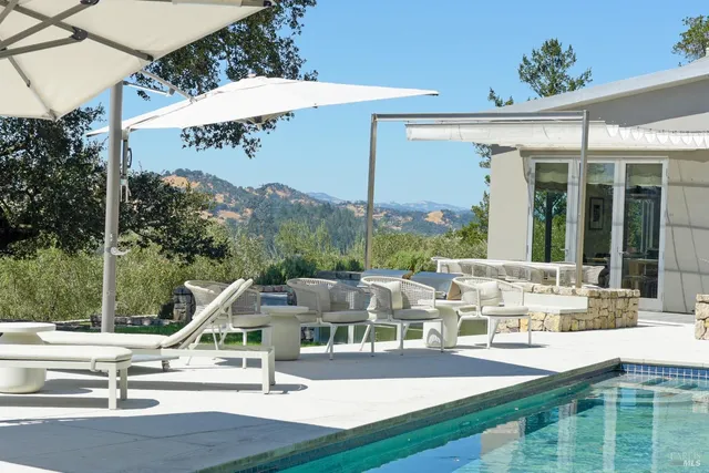 a bedroom with a bed and a lamp on the dresser