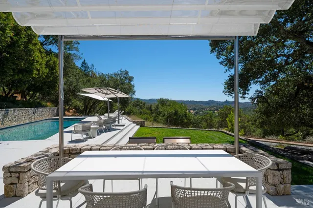 a view of backyard with small cabin and wooden fence