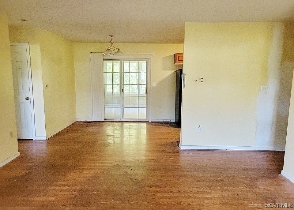 1725 Beaver Dam Road Warsaw, VA 22572 - Photo 10 of 22 a view of empty room with wooden floor and fan