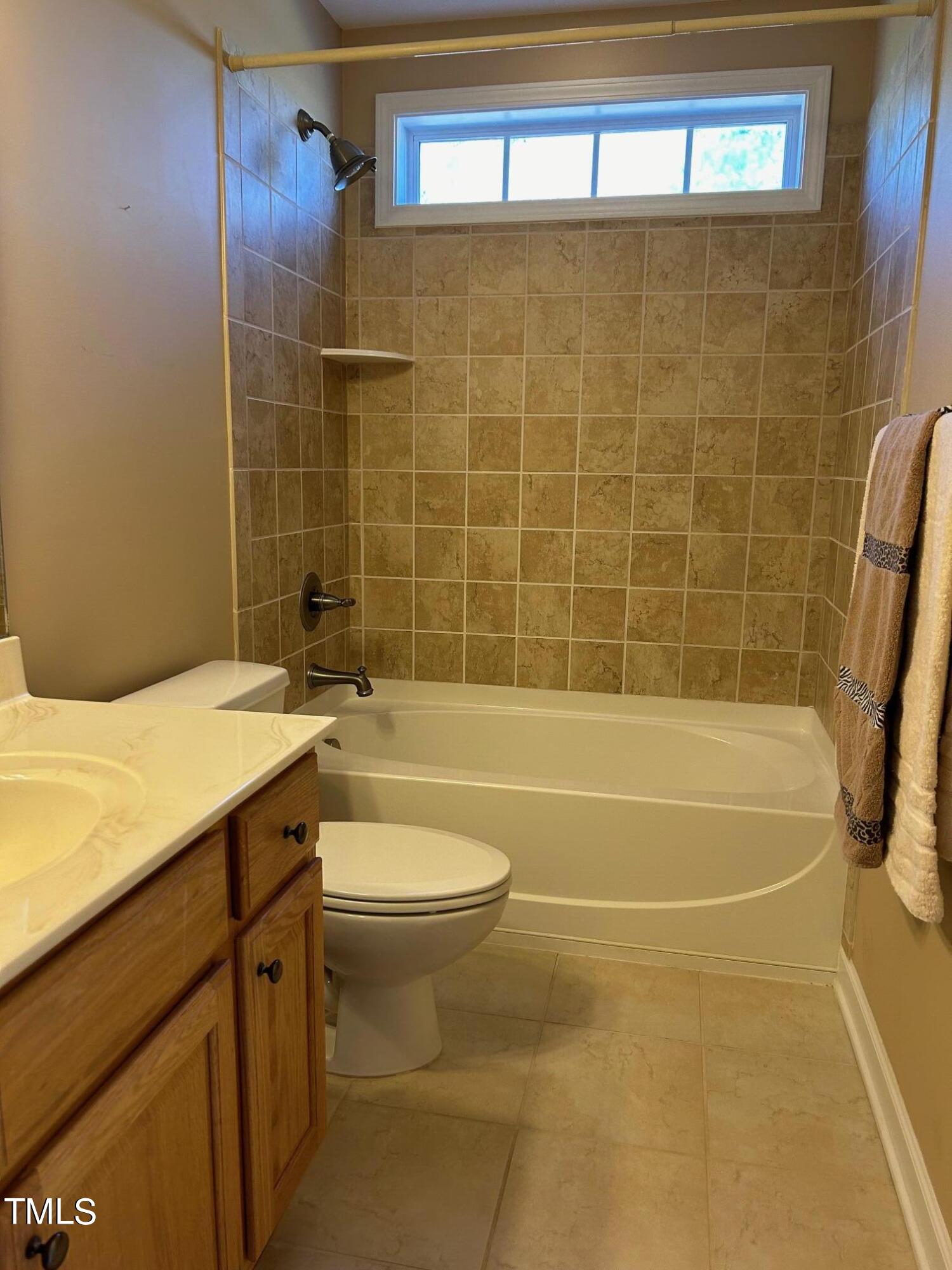 636 Seastone Street Raleigh, NC 27603 - Photo 30 of 39 a bathroom with a sink a toilet and shower