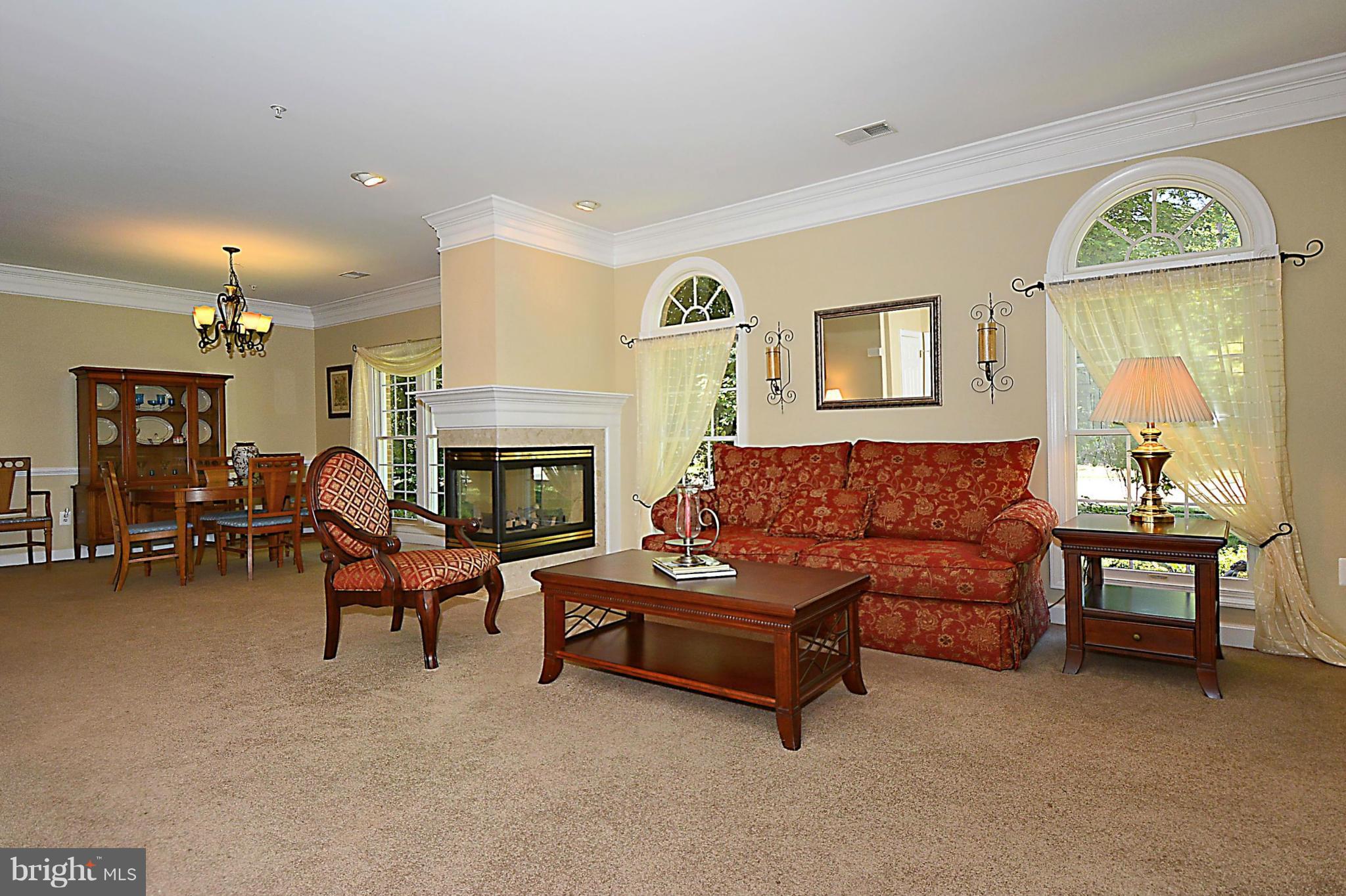 383 Colony Point Place Edgewater, MD 21037 - Photo 6 of 30 Living Room Open to Dining Room with Gas Fireplace