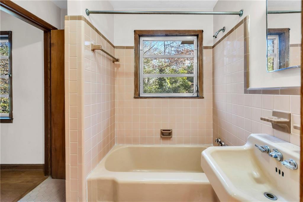 2425 Melinda Court Northeast Atlanta, GA 30345 - Photo 17 of 22 a bathroom with a tub a sink and a window