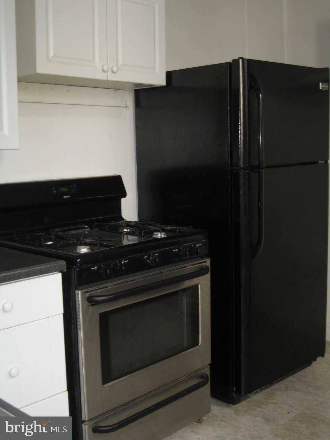 1415 Riverside Avenue Baltimore, MD 21230 - Photo 4 of 24 a stove top oven sitting inside of a kitchen