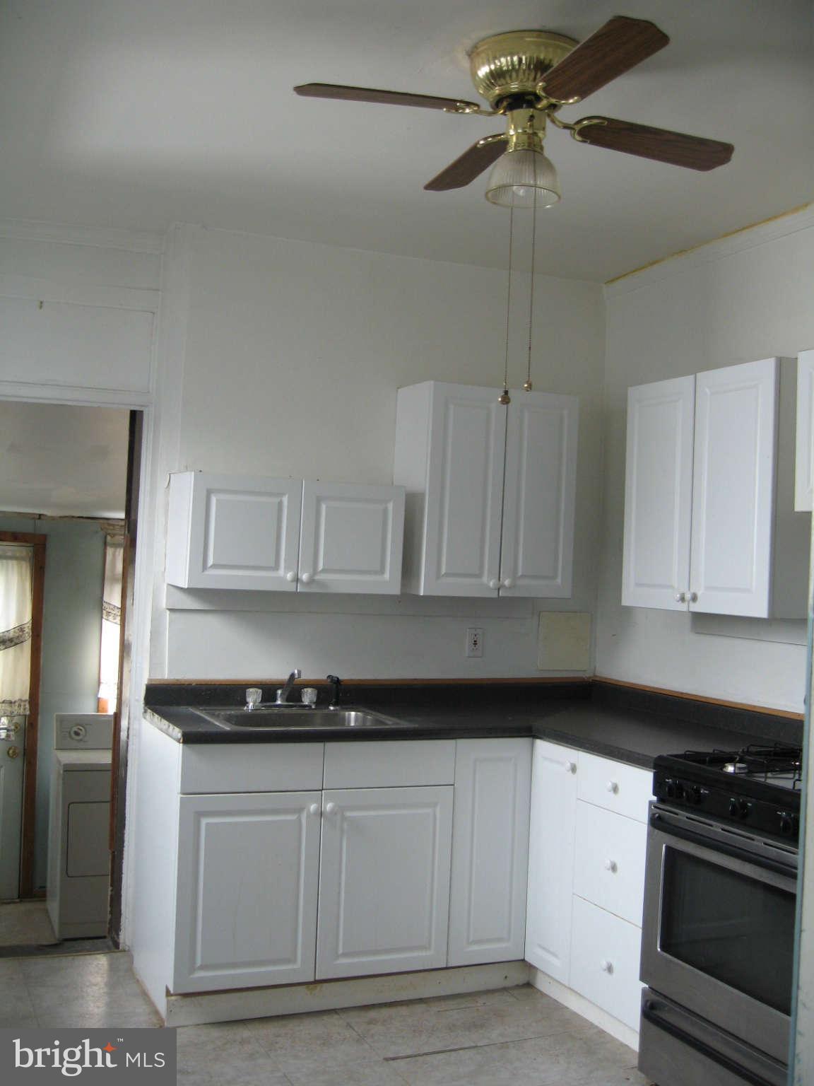 1415 Riverside Avenue Baltimore, MD 21230 - Photo 5 of 24 a kitchen with granite countertop a stove a sink and dishwasher