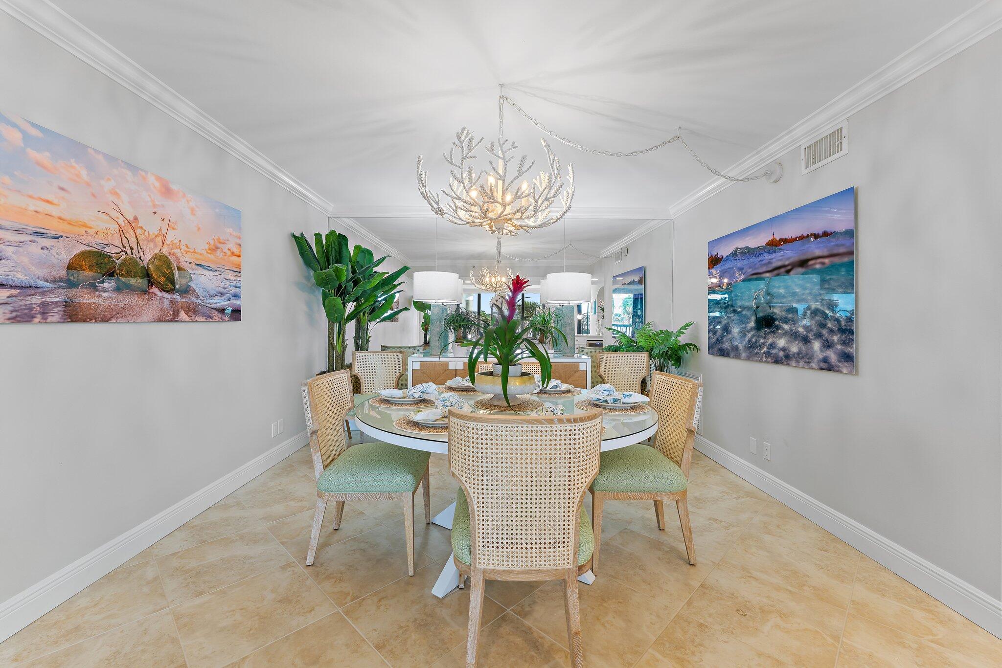 19670 South Beach Road, Unit B303 Jupiter, FL 33469 - Photo 28 of 104 a dining room with furniture a large window and a potted plant