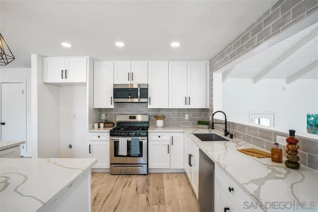 751 Crestview Road Vista, CA 92081 - Photo 11 of 24 a kitchen with a sink a stove and cabinets